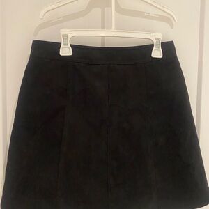Black suede mini skirt with silver buttons in front.